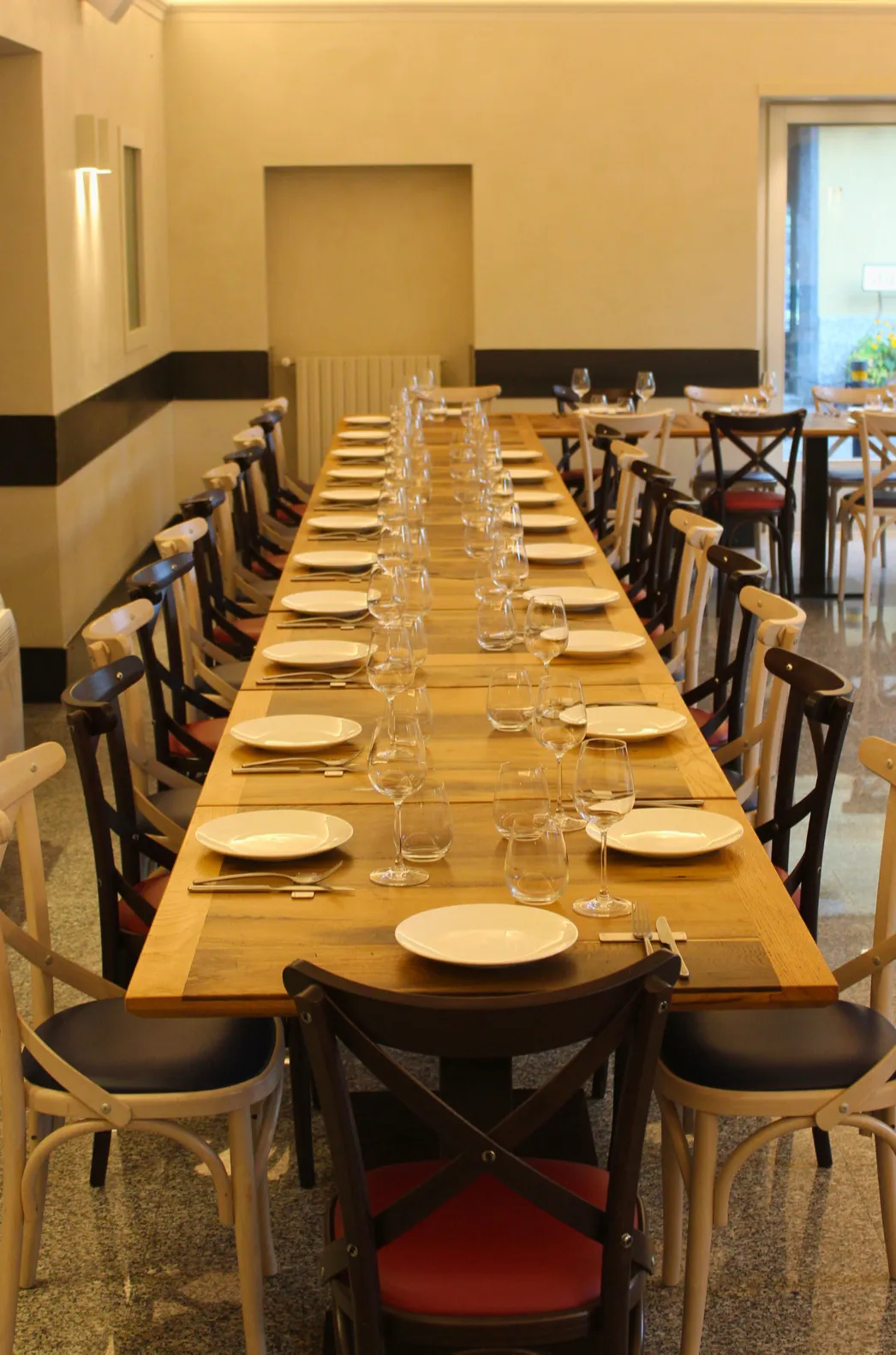 The dining room with a long wooden table laid for a meal